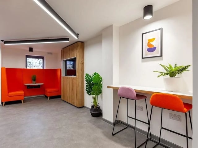 Orange booth seating wood panel TV area lounge area at Devonshire Courtyard in Sheffield Student Accommodation