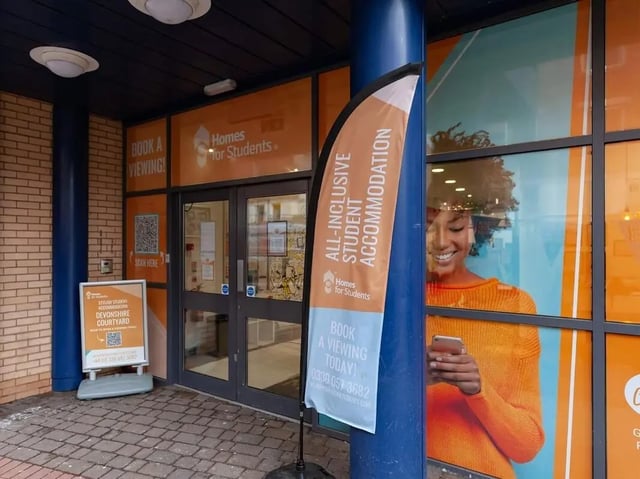 Building entrance with promotional flag and signage exterior at Devonshire Courtyard in Sheffield Student Accommodation