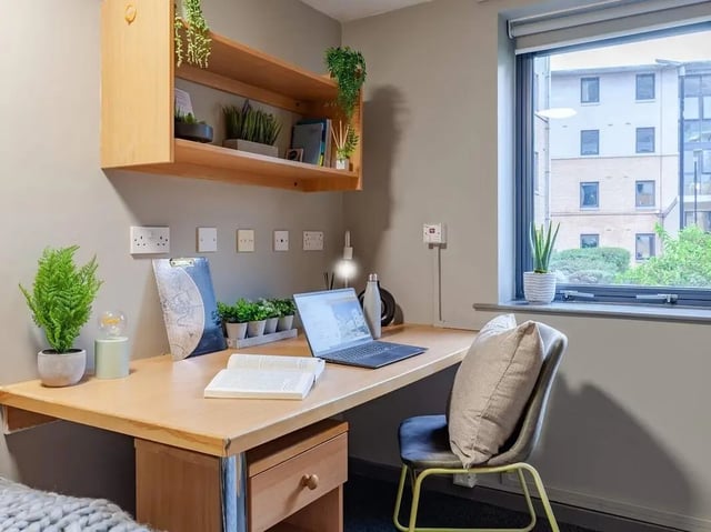 Desk with laptop plants chair and shelf Study area at Devonshire Courtyard in Sheffield Student Accommodation