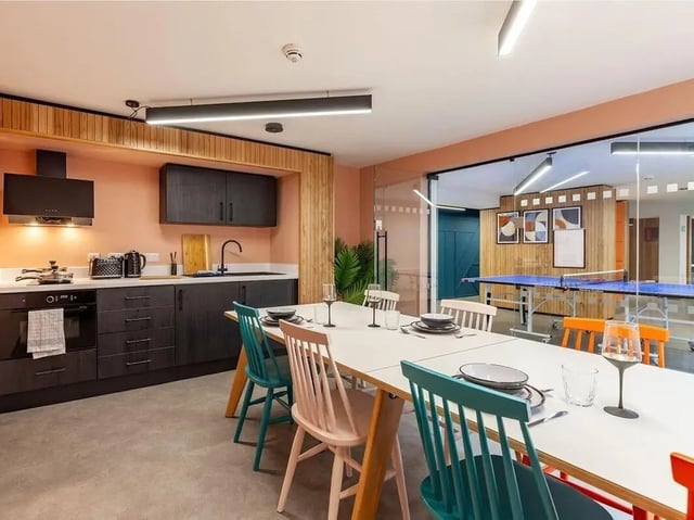 Kitchen dining area with ping pong table living room at Devonshire Courtyard in Sheffield Student Accommodation