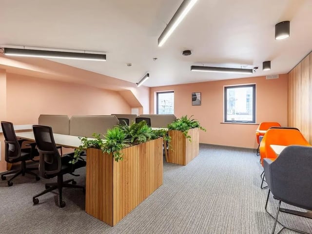 Desks chairs plants and orange chairs study area at Devonshire Courtyard in Sheffield Student Accommodation