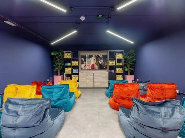 Beanbag chairs facing screen shelves filled with snacks playing area at Devonshire Courtyard in Sheffield Student Accommodation