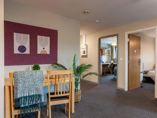 Dining table chairs artwork plant hallway and bedroom at Crown House - Reading in Reading Student Accommodation