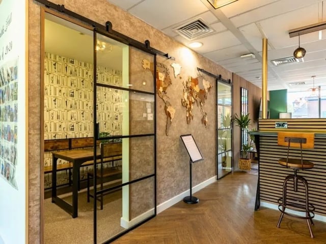 Table with benches and world map lounge at Kendrick Hall in Reading Student Accommodation