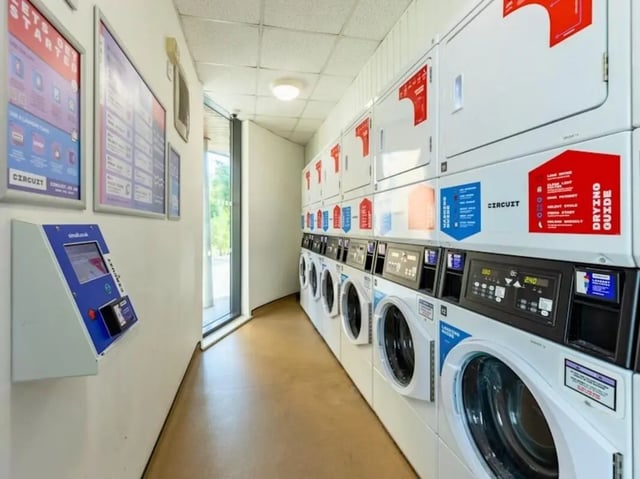 Washing machines dryers payment kiosk laundry room at Kendrick Hall in Reading Student Accommodation