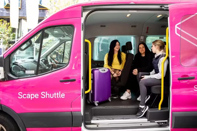 Three students with luggage inside shuttle van at Scape Swanston in Melbourne Student Accommodation