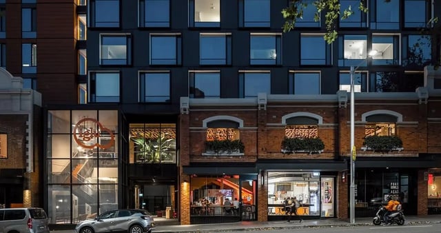 Modern building with shops and stairs exterior at Iglu Redfern in Sydney Student Accommodation