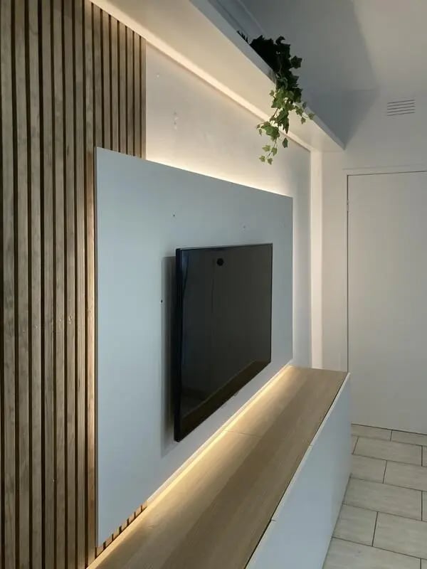 Modern TV wall with wood paneling and lighting living room. at Classical House in Melbourne Student Accommodation