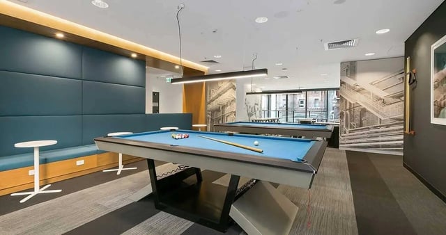 Pool tables with balls and cues playing area at Iglu Central Park in Sydney Student Accommodation
