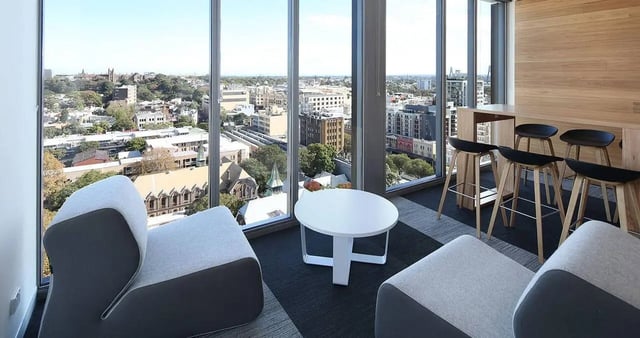 Modern seating bar stools and city view lounge at Iglu Central Park in Sydney Student Accommodation
