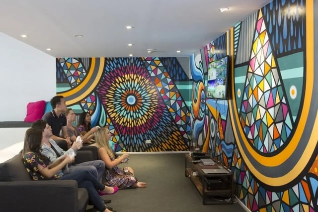 Students play video games on sofas living room at Sydney University Village in Sydney Student Accommodation