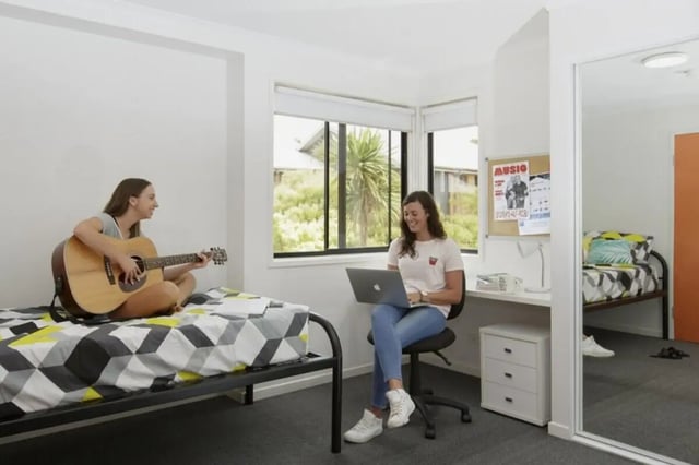 Two students guitar laptop study desk bedroom at Student Village North Ryde in Sydney Student Accommodation