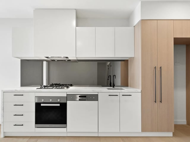 Modern kitchen with oven dishwasher cabinets and sink kitchen at BELONG Clayton Melbourne in Melbourne Student Accommodation