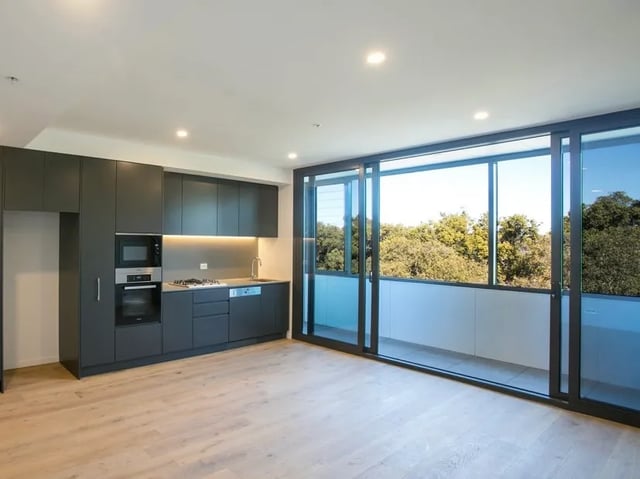 Dark grey kitchen cabinets microwave oven and stovetop Kitchen at BELONG Newcastle NSW in Newcastle Student Accommodation