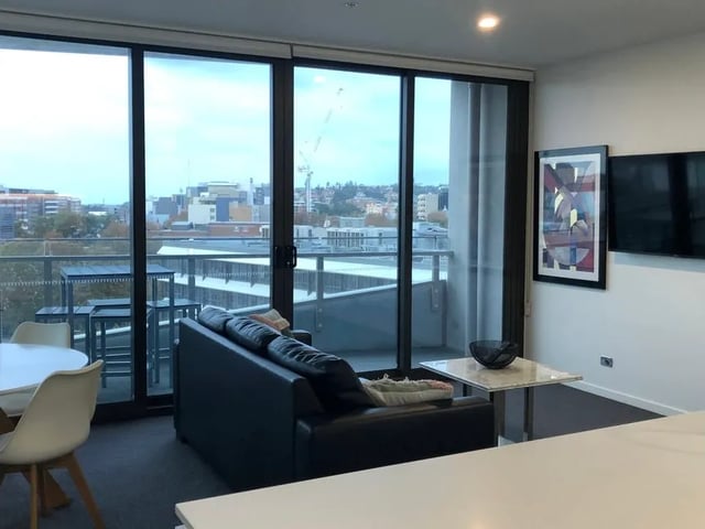 Modern living room with sofa and artwork Living room at BELONG Newcastle NSW in Newcastle Student Accommodation