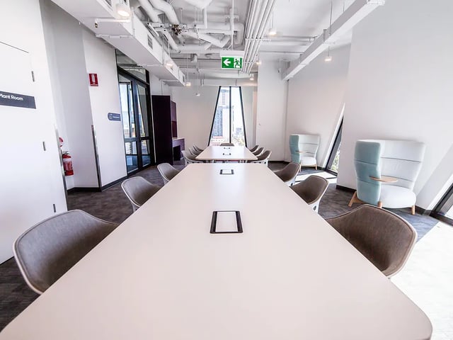 Long tables chairs fire extinguisher study room at Yugo Adelaide City in Adelaide Student Accommodation