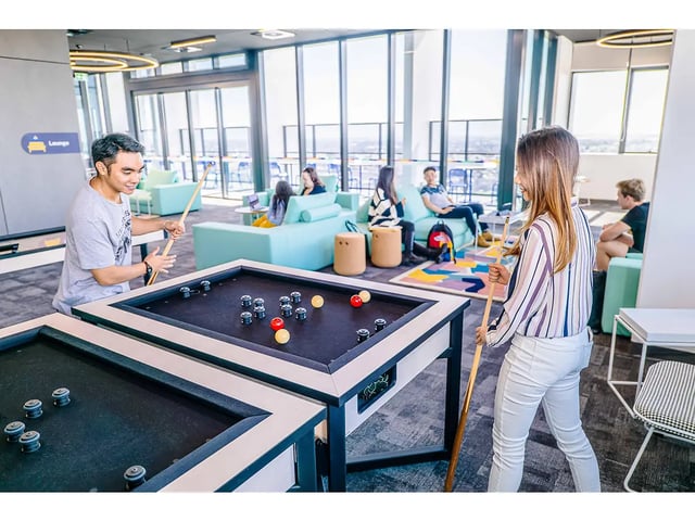 Pool table with people playing lounge at Yugo Adelaide City in Adelaide Student Accommodation