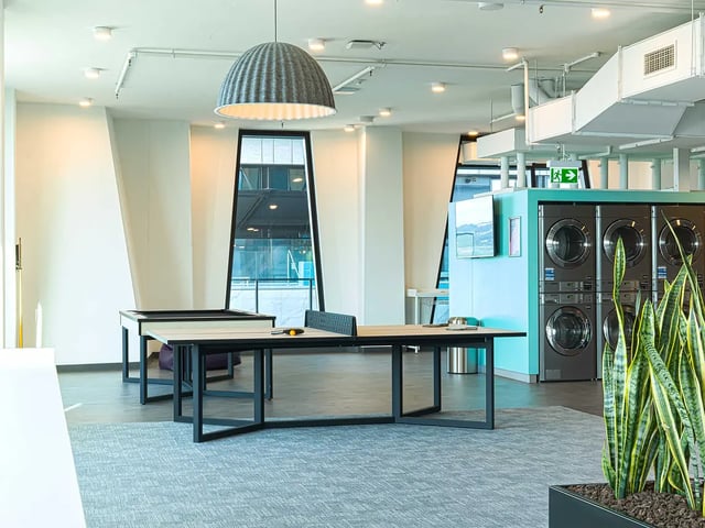 Ping pong table washing machines plants common area at Yugo Adelaide City in Adelaide Student Accommodation