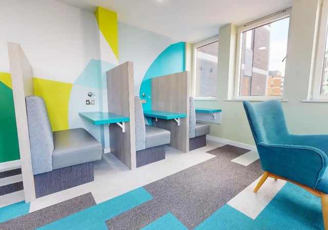 Study booths and blue chair lounge area at iQ Newland House in Nottingham Student Accommodation