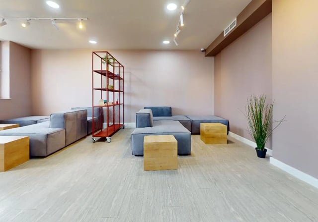 Modern grey sofas red shelving wooden cubes common area at iQ Newland House in Nottingham Student Accommodation