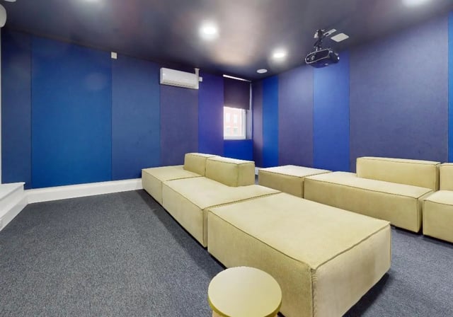 Modular sofas projector and AC unit living room at iQ Newland House in Nottingham Student Accommodation