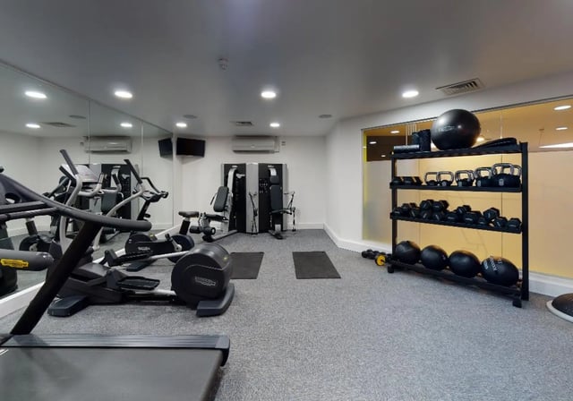Gym equipment treadmill exercise bikes weight rack gym balls fitness room at iQ Newtown House in Nottingham Student Accommodation