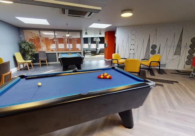 Pool tables chairs and patterned wall playing area at iQ Newtown House in Nottingham Student Accommodation