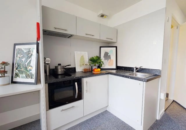 Modern student kitchen with microwave and sink kitchen at iQ Newtown House in Nottingham Student Accommodation