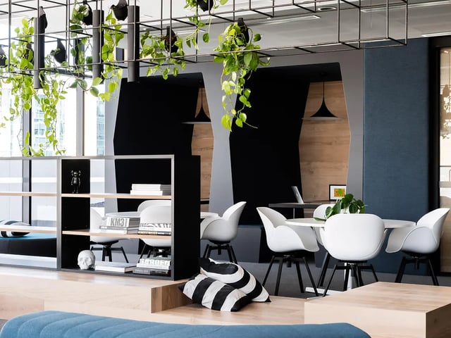 White chairs round table black shelves living room at Yugo Perth City in Perth Student Accommodation