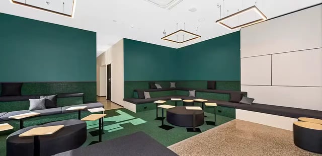 Tiered seating with tables and sofas communal area at Scape Waymouth in Adelaide Student Accommodation