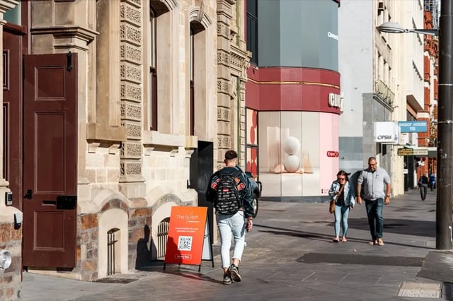 Red sign with QR code exterior at The Switch Adelaide in Adelaide Student Accommodation