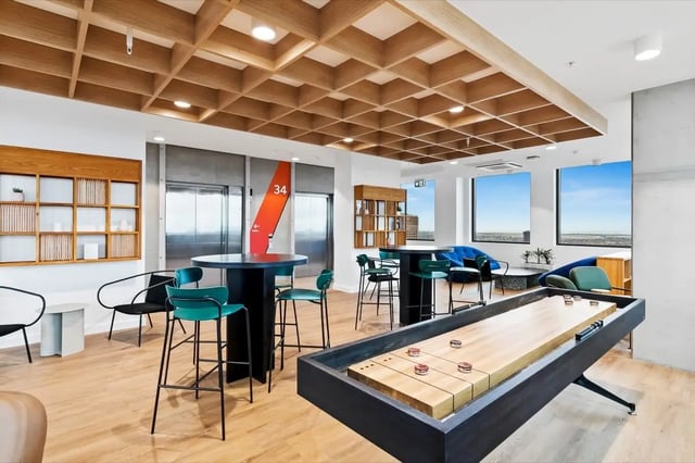 Shuffleboard table high tables blue sofas lounge area at The Switch Adelaide in Adelaide Student Accommodation