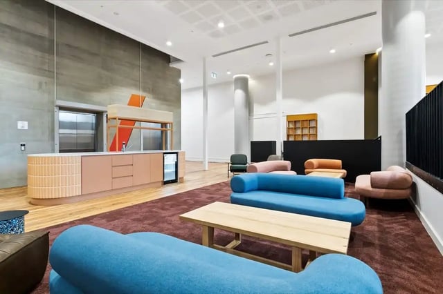 Bar with fridge elevator couches coffee table lounge at The Switch Adelaide in Adelaide Student Accommodation