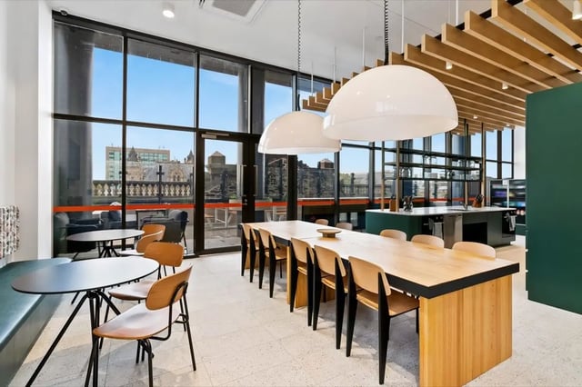Dining table and chairs with kitchen area kitchen at The Switch Adelaide in Adelaide Student Accommodation
