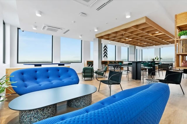 Blue couches table chairs large windows lounge area at The Switch Adelaide in Adelaide Student Accommodation