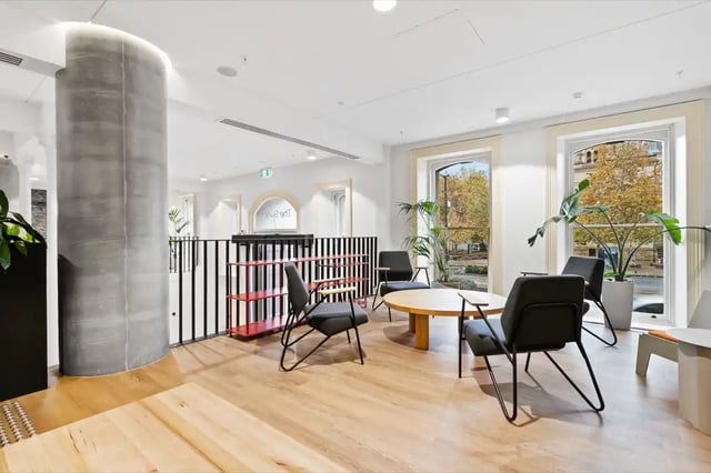 Chairs and table near large windows communal area at The Switch Adelaide in Adelaide Student Accommodation