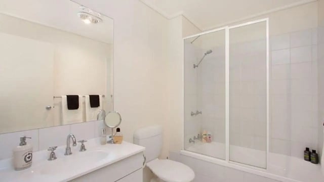Sink toilet shower tub with towels bathroom at Student Living On ABeckett in Melbourne Student Accommodation
