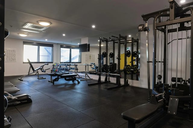 Gym equipment weights benches mirrors gym at dwell East End Adelaide in Adelaide Student Accommodation