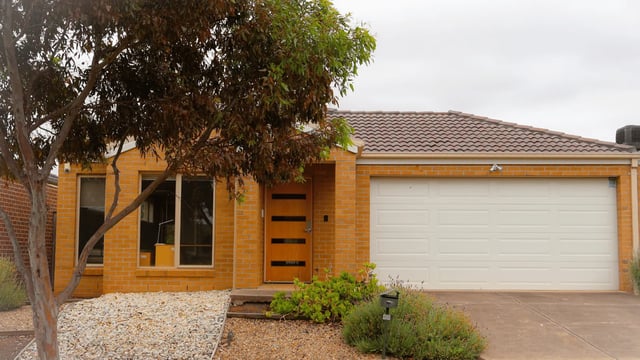 Brick house with garage and trees exterior at La Trobe University Regional Housing - Melton in Melton Student Accommodation