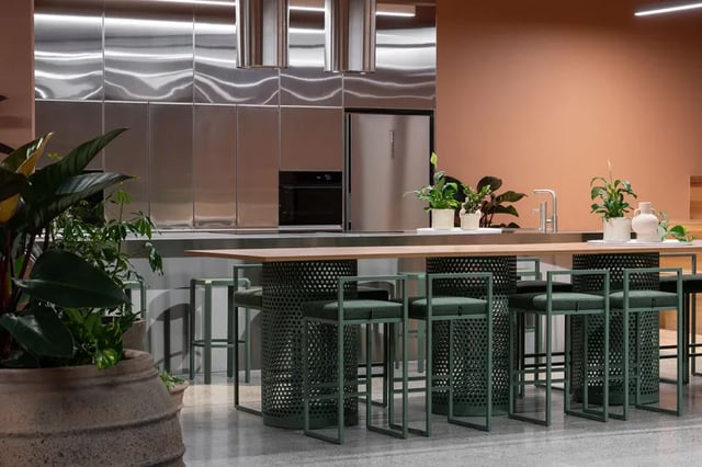 Stainless steel appliances bar stools plants kitchen area at Campus House in Melbourne Student Accommodation