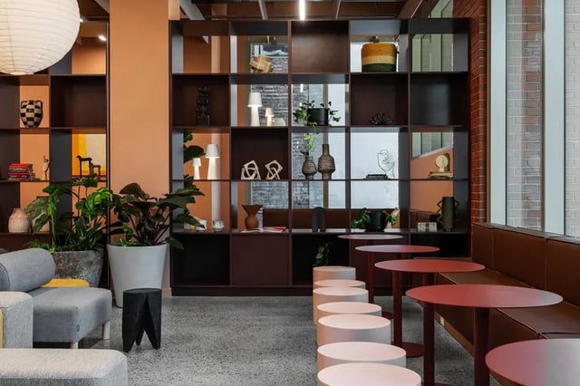 Shelving plants seating tables living room at Campus House in Melbourne Student Accommodation