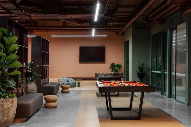 Pool table bean bags lounge seating and plants common area at Campus House in Melbourne Student Accommodation