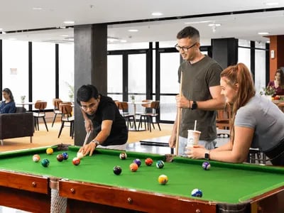 People playing billiards in a common room. at UniLodge Darwin in Darwin Student Accommodation