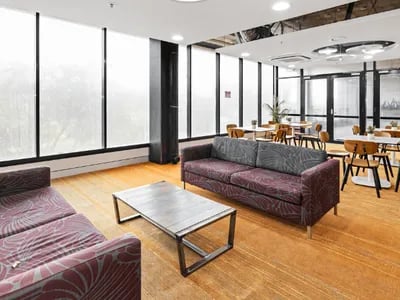 Two sofas coffee table dining tables living room at UniLodge Darwin in Darwin Student Accommodation