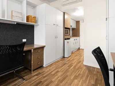 Desk chair cabinets microwave fridge kitchen studio apartment at UniLodge Darwin in Darwin Student Accommodation