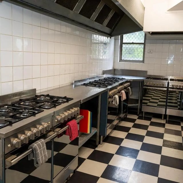 Commercial stoves and checkered floor kitchen at Sydney Student Living Concord in Sydney Student Accommodation
