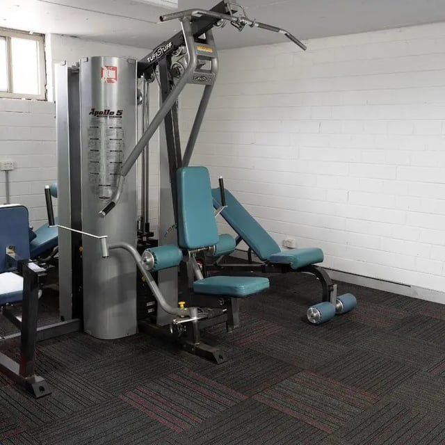 Weight machine with blue pads workout area exterior at Sydney Student Living Concord in Sydney Student Accommodation
