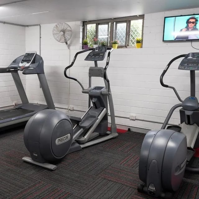 Treadmill elliptical machines and TV gym area at Sydney Student Living Concord in Sydney Student Accommodation