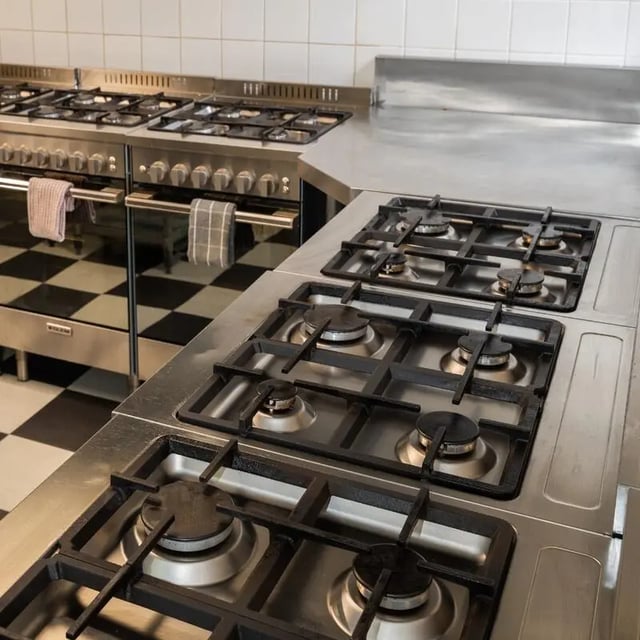 Commercial stoves with checkered floor kitchen at Sydney Student Living Concord in Sydney Student Accommodation