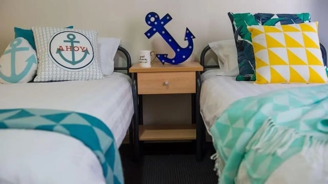 Beds with nautical pillows and throws Bedroom at Student Living on Flinders in Melbourne Student Accommodation